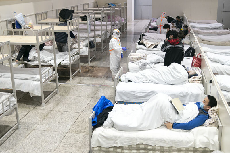 WUHAN, Feb. 5, 2020 -- Patients infected with the novel coronavirus are seen at a makeshift hospital converted from an exhibition center in Wuhan, central China's Hubei Province, Feb. 5, 2020. The first makeshift hospital converted from an exhibition center in China's epidemic-hit Wuhan city began accepting patients Wednesday. The hospital can provide about 1,600 beds to infected patients. 