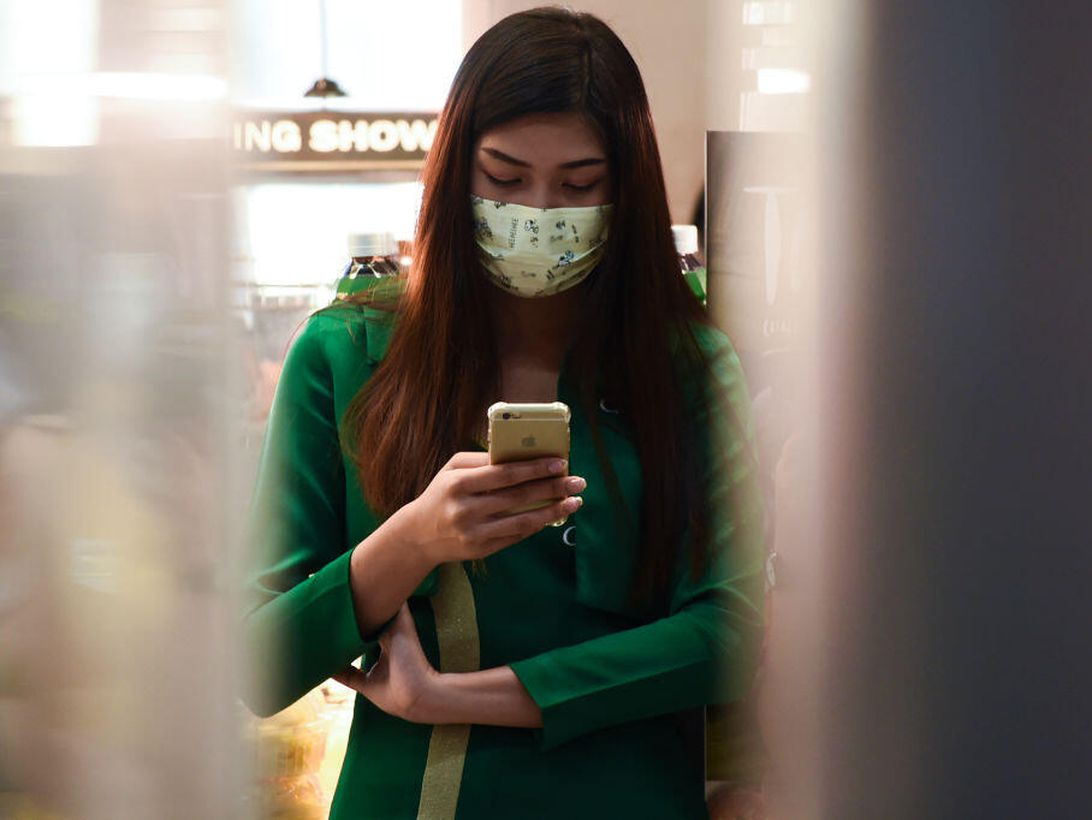 Amid the global scare over the coronavirus, a woman wears a mask at an airport in Thailand.