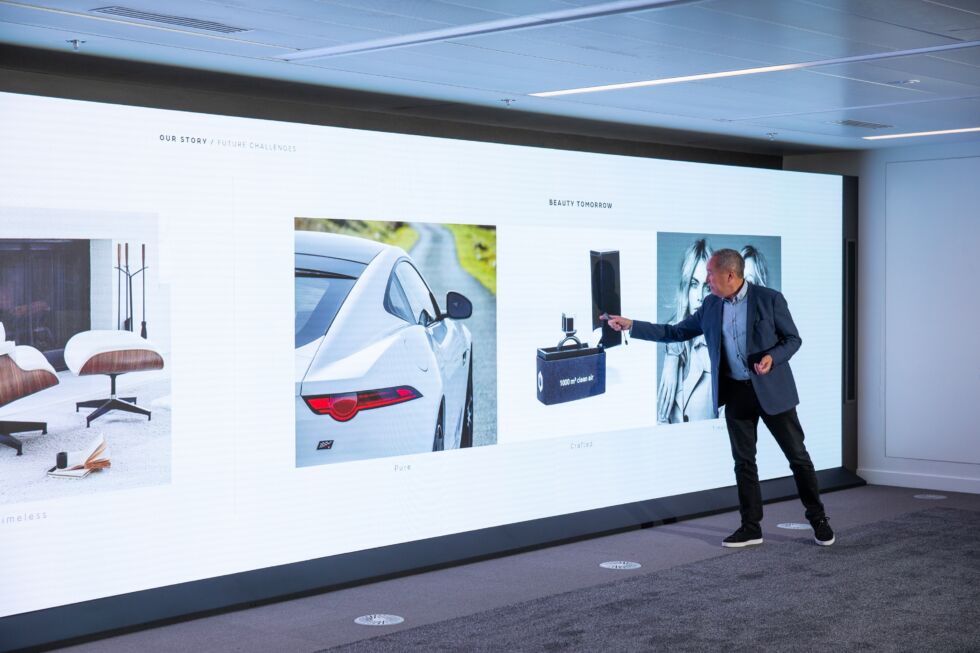 Jaguar's director of design, Julian Thomson, stands in front of a gargantuan display at the company's new design studio.