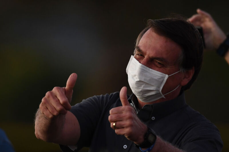 Brazilian President Jair Bolsonaro gives the thumbs up to supporters from the Alvorada Palace in Brasilia, on July 20, 2020, amid the new coronavirus pandemic. (Photo by EVARISTO SA / AFP) (Photo by EVARISTO SA/AFP via Getty Images)